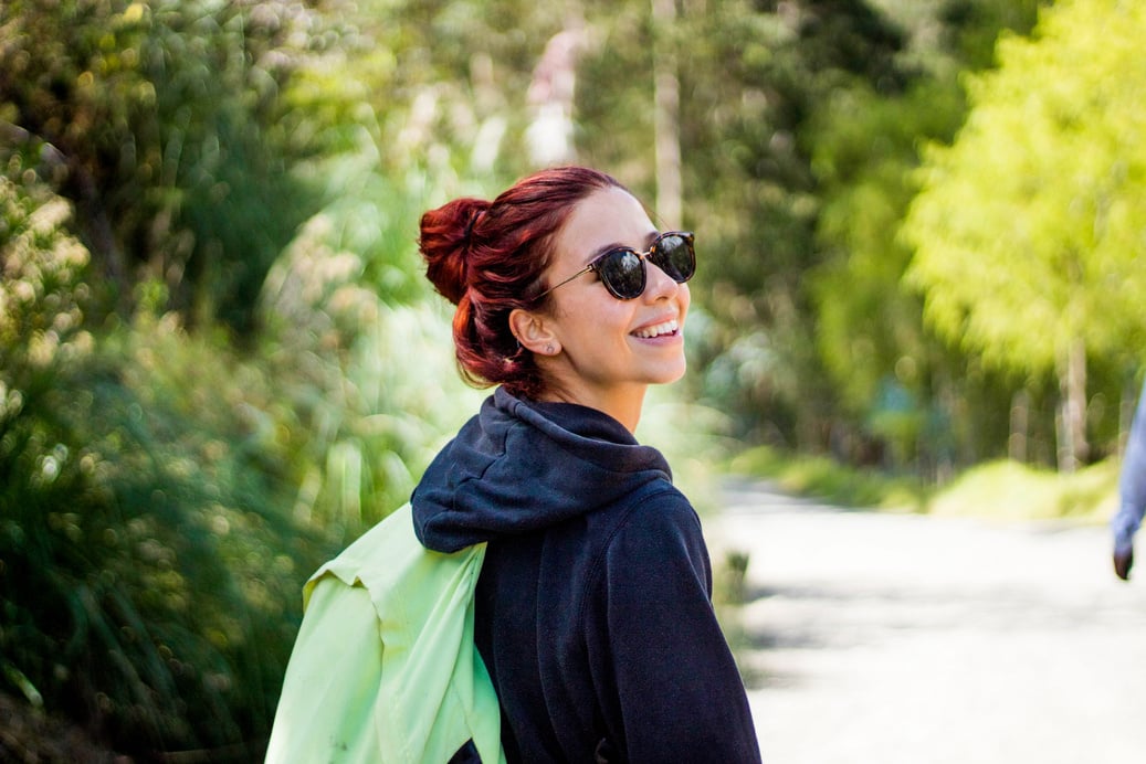 Happy Colombian woman with red hair and sunglasses